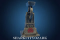 Metallic shark fin trophy on a blue background, featuring 'Shark City Ozark' branding. jaws movie