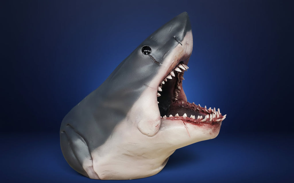 Shark model with open mouth against a blue background. jaws bruce shark
