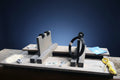 Wooden router table with various tools and cables on a wooden surface outdoors.