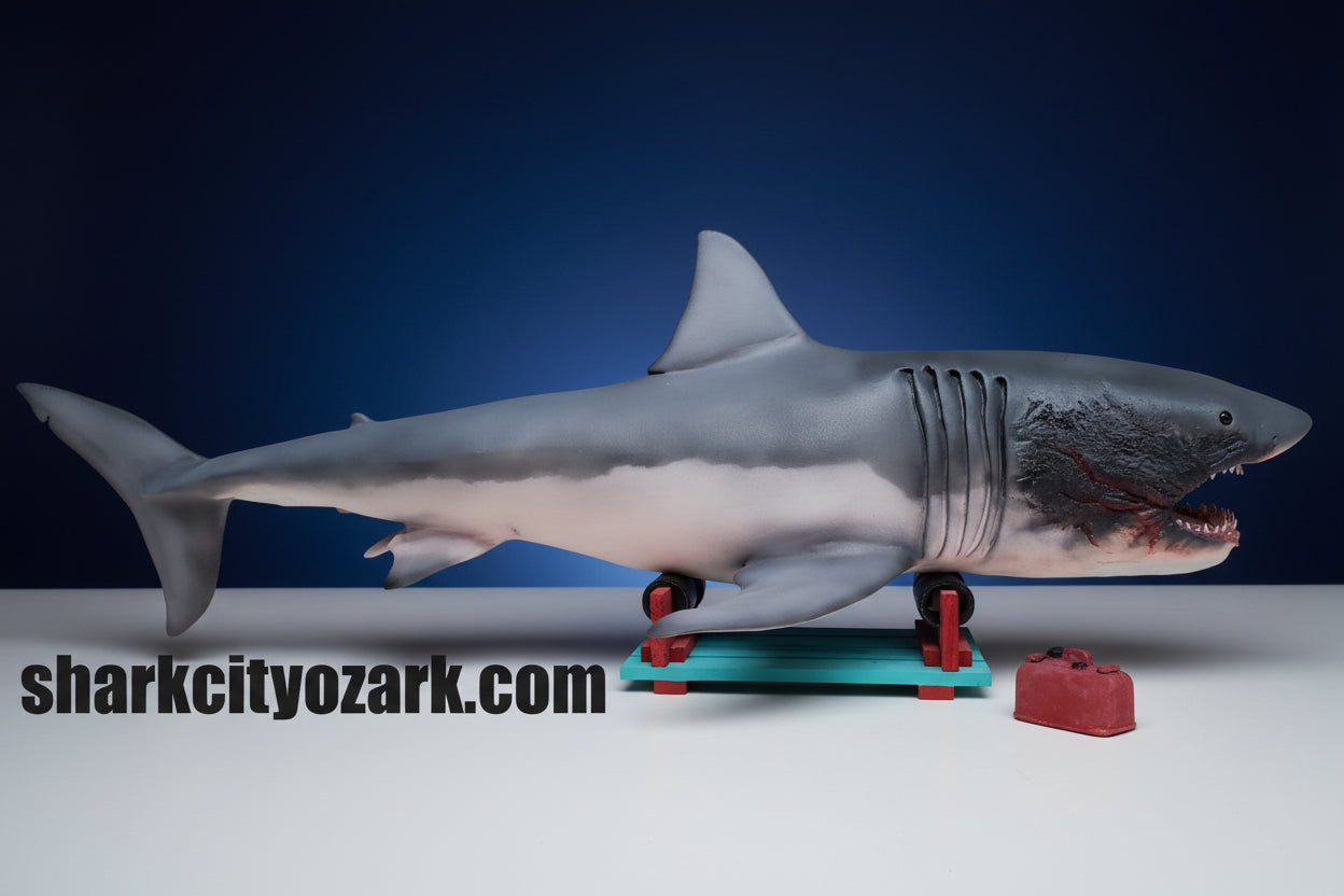 Shark toy figure on a white background with 'sharkcityozark.com' text.