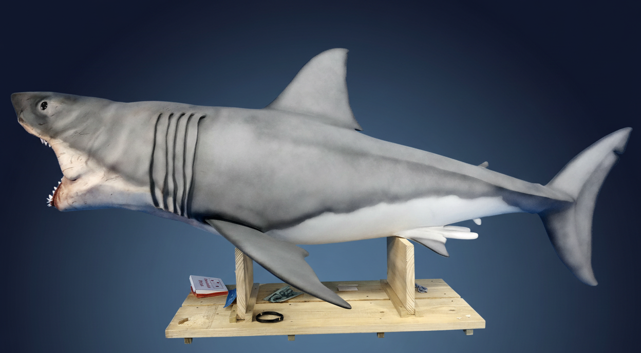 Shark sculpture on stand with dark gradient blue background